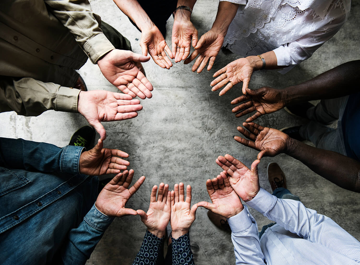 group diverse hands palms circle support together teamwork aerial view